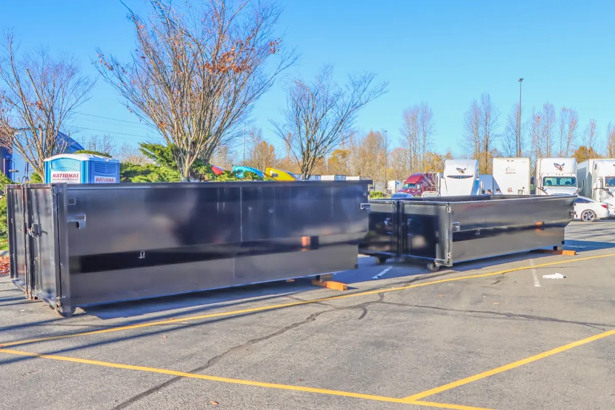 Professional dumpster rental service with roll-off container on residential driveway in Williamson